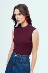 Top tejido sin mangas con cuello alto, con rayas verticales en tonos marrón y azul, y diseño ajustado.