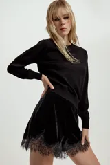 Jersey básico de cuello redondo y manga larga, confeccionado en hilatura de lana 100% con acabado de punto liso.