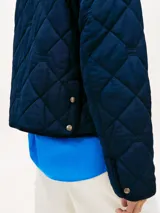 Campera acolchada Tommy Hilfiger de color azul marino, con diseño pespuntado en rombos, cierre frontal de botones a presión y bolsillos aplicados con solapa.