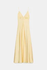 Vestido midi de tejido satinado en color amarillo, con escote en pico, tirantes finos ajustables, detalles de frunces en el pecho y falda de corte fluido.