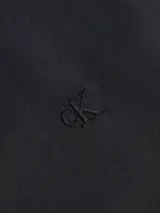 Camisa negra de algodón elástico mercerizado, corte slim, cuello en punta, puños segados, bajo redondeado y botones de nácar.