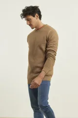 Sweater de punto fino azul con cuello redondo y terminaciones elásticas en canalé.