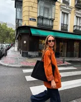 Cartera tipo tote bag color negro de gran capacidad, con asas largas para llevar al hombro y bolsillo exterior frontal.