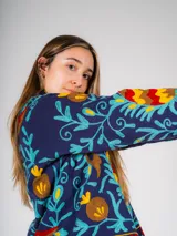 Chaqueta corta azul marino con bordados florales multicolores.