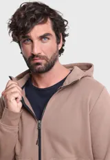 Canguro color tostado con cierre frontal, capucha, bolsillos con cierre y puños y dobladillo acanalados.