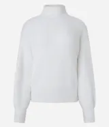 Suéter de poliamida afelpada color blanco, con cuello alto y mangas largas. Presenta una textura suave de pelos artificiales y puños acanalados.