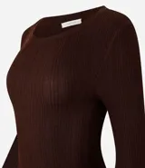 Suéter de punto acanalado color beige, con cuello redondo y mangas largas. Confeccionado en tejido tricot con textura suave y ajuste al cuerpo.