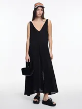 Vestido largo negro, sin mangas, con escote en V profundo y tajo central en la falda.