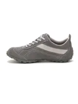 Zapato de gamuza color gris de la marca Caterpillar, modelo Iris, con cordones claros, suela de goma duradera y detalles en color lila con el nombre de la marca en el lateral.
