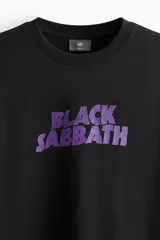 Remera de algodón color negro con cuello redondo y mangas cortas. Presenta un estampado frontal con el logo de la banda Black Sabbath en color violeta.