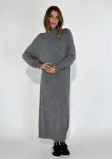 Vestido largo gris de tejido de punto con cuello alto y mangas largas.