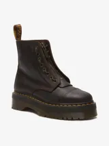 Bota Dr. Martens modelo Sinclair, color marrón oscuro, con plataforma gruesa y suela ranurada. Confeccionada en cuero Crazy Horse, presenta un aspecto desgastado. Incluye cierre frontal de cremallera extraíble, cordones y costura amarilla en el ribete.