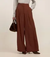 Pantalón de vestir negro de viscosa, corte wide leg, cintura alta con pliegues y pinzas.