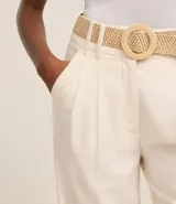 Pantalón wide leg de cintura alta color crudo, confeccionado en viscolino, con trabillas en la cintura, cierre tradicional y pliegues. Incluye cinturón de rafia artificial.
