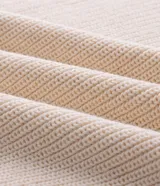 Buzo de tricot de algodón con textura acanalada, cuello alto con cierre frontal y mangas largas. Presenta un diseño de calce regular con puños y ruedo acanalados.
