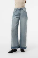 Jean wide leg de tiro alto y calce relajado, confeccionado en denim azul claro con lavado suave y dobladillo ancho en contraste. Cuenta con perneras amplias y corte recto.