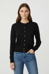 Cardigan de tejido de punto, color negro con rayas horizontales blancas, corte al cuerpo y cuello redondo a la base. Posee cierre frontal con botones dorados.