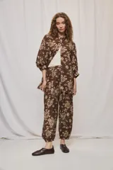 Pantalón de tiro alto y silueta amplia con estampado floral, pinzas en el frente, volumen relajado y terminación elastizada en los tobillos.