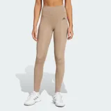 Calza deportiva de entrenamiento Adidas Optimé Essentials, color tostado de tiro alto con tecnología AEROREADY. Cuenta con cintura que se mantiene firme y costuras selladas.