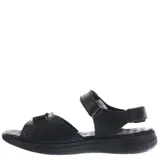 Sandalias de cuero color marrón con ajuste de velcro en el empeine y el talón. Presentan una suela de goma ergonómica en tono gris y logo de la marca grabado en la tira superior.
