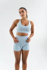 Conjunto deportivo color beige, compuesto por un top con escote redondo y unos shorts ajustados.