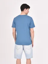 Remera melange color azul con diseño estampado frontal de paisajes y texto.