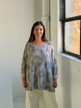 Sweater de punto con diseño animal print difuminado en tonos verdes y grisáceos, de corte holgado, cuello redondo y mangas largas con puños vueltos en color liso.