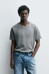 Camiseta de manga corta color amarillo pálido, con cuello redondo acanalado y corte relajado.