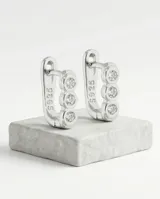 Caravanas tipo argolla pequeña de plata 925, con diseño lineal adornado con tres circonias engastadas.
