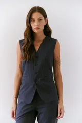 Chaleco azul con escote en V, cierre frontal con botones y bolsillos simulados.