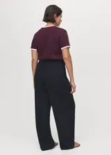 Pantalón de vestir de tiro bajo y diseño wide leg color azul marino, con pinzas en la parte delantera y bolsillos laterales.