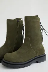 Botas de caña media color marrón, con cordones en la parte trasera y cierre lateral con cremallera.