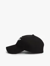 Gorra de béisbol negra de seis paneles con ojales de ventilación y botón superior. Presenta bordados en hilo blanco con fuente Script: las iniciales "TH" en la parte delantera y el nombre de la marca en el lateral.