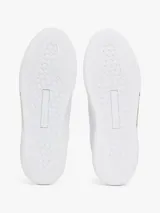 Zapatillas Tommy Hilfiger de piel blanca con detalles dorados en el talón y la lengüeta.