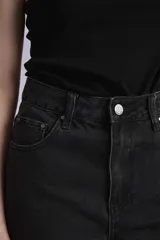 Bermuda de jean color negro, tiro alto y corte recto.