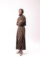 Falda larga de corte evasé con estampado de cuadros en tonos tierra, presenta cintura definida y bolsillos laterales.