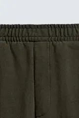 Pantalón jogger de algodón color verde oscuro, con efecto lavado, corte balloon fit y cintura elástica. Presenta bolsillos delanteros y bolsillos traseros de plastrón.