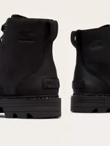 Bota Sorel Revel Rd Boot Lace de cuero negro, estilo informal con cordones, suela de caucho EVERTREAD™ moldeada y construcción impermeable con costuras selladas.