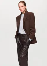 Pantalón de cuero sintético color marrón, de corte recto y tiro medio con pinzas en la cintura.