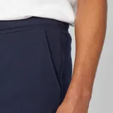 Bermudas de chándal azul marino de felpa ligera, con cintura elástica ajustable mediante cordón blanco de ajuste y bolsillos laterales.