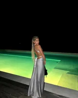 Vestido largo color gris con espalda descubierta y tiras finas que recorren el torso.