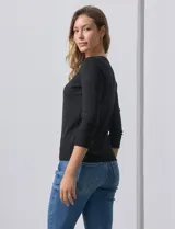 Cardigan blanco de tejido fino con abertura central y botones.