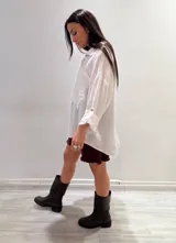 Camisa negra de manga larga con cuello clásico y cierre frontal con botones.