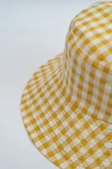 Gorro tipo bucket con estampado de cuadros vichy en color amarillo y blanco.