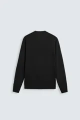 Jersey color crudo de tejido de punto, con cuello redondo y mangas largas. Corte amplio y terminaciones en rib.