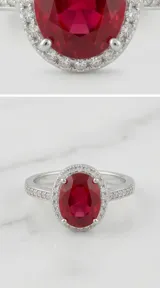 Anillo de plata 925 con piedra central de raíz de rubí en corte ovalado, rodeada por un halo de circonias y banda decorada con circonias adicionales.