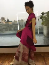 Vestido fucsia con estampado abstracto en tonos borgoña, corte midi, sin mangas, con escote en la espalda y lazo en la cintura.