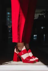 Sandalias de plataforma color crema, con tiras anchas de charol y hebilla ajustable en el tobillo.