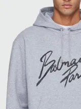 Buzo con capucha Balmain de corte holgado, confeccionado en algodón gris, con estampado frontal del logo de la marca en color negro.