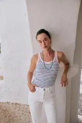 Musculosa de punto rib color blanco, con escote redondo y diseño ajustado.